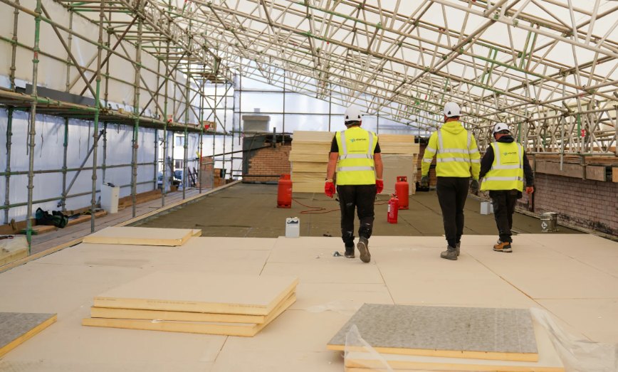 Starfish Construction team walking across a new roof deck during RAAC remediation in Leith, Edinburgh